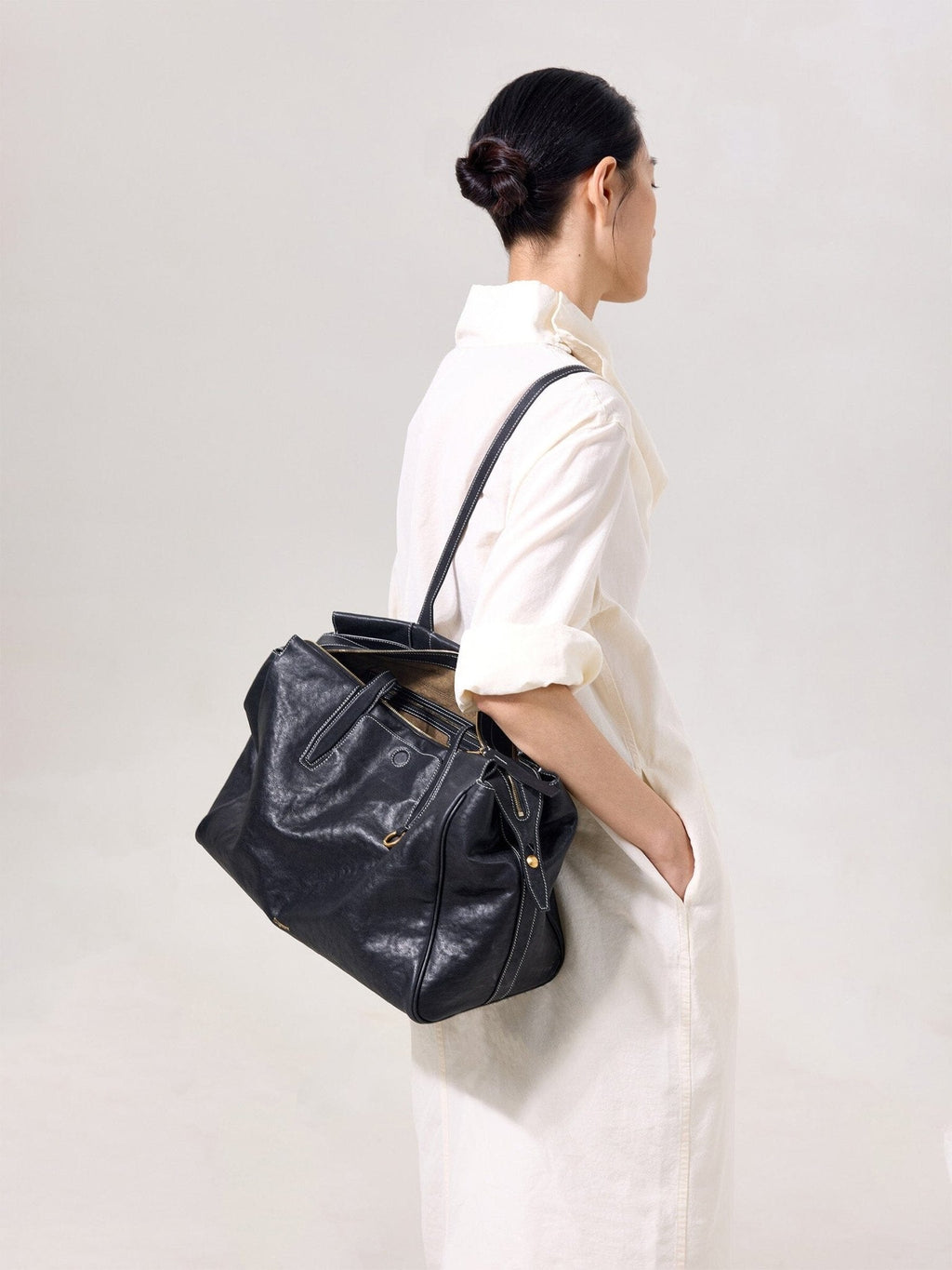 Songmont Medium Yore Duffle Bag Onyx - carried on the shoulder, side view