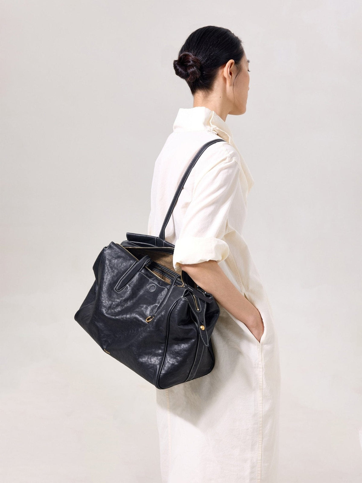 Songmont Medium Yore Duffle Bag Onyx - carried on the shoulder, side view