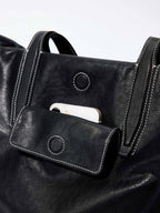 Songmont Medium Yore Duffle Bag Onyx - front pocket with a phone tucked in