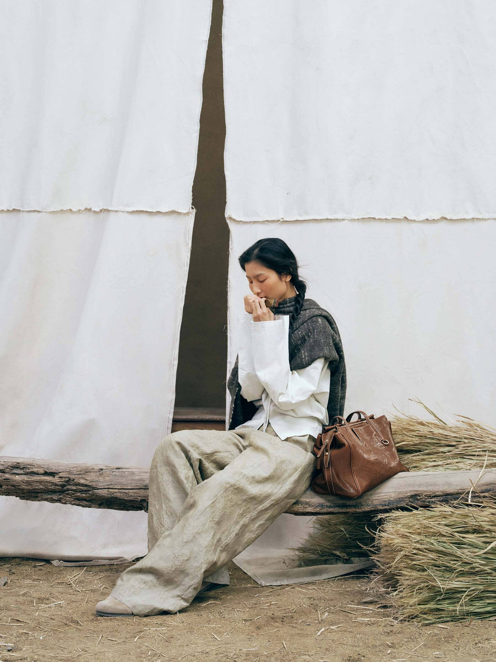Songmont Medium Yore Duffle Bag Sandal - styled with a seated model on a bench