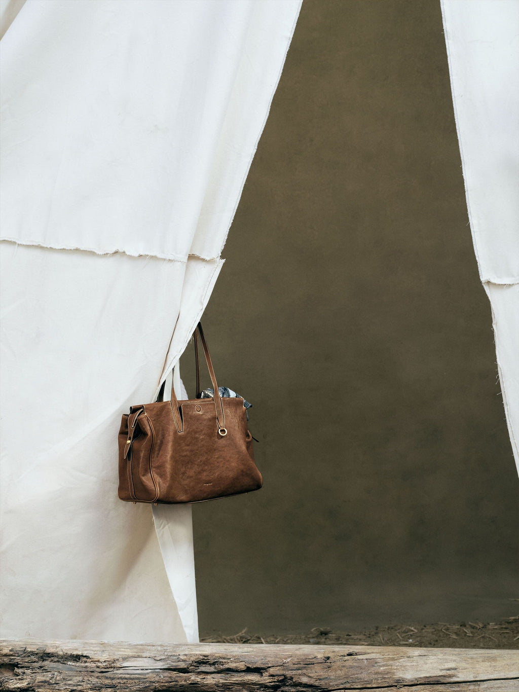 Songmont Medium Yore Duffle Bag Sandal - hanging against a canvas backdrop
