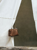 Songmont Medium Yore Duffle Bag Sandal - hanging against a canvas backdrop