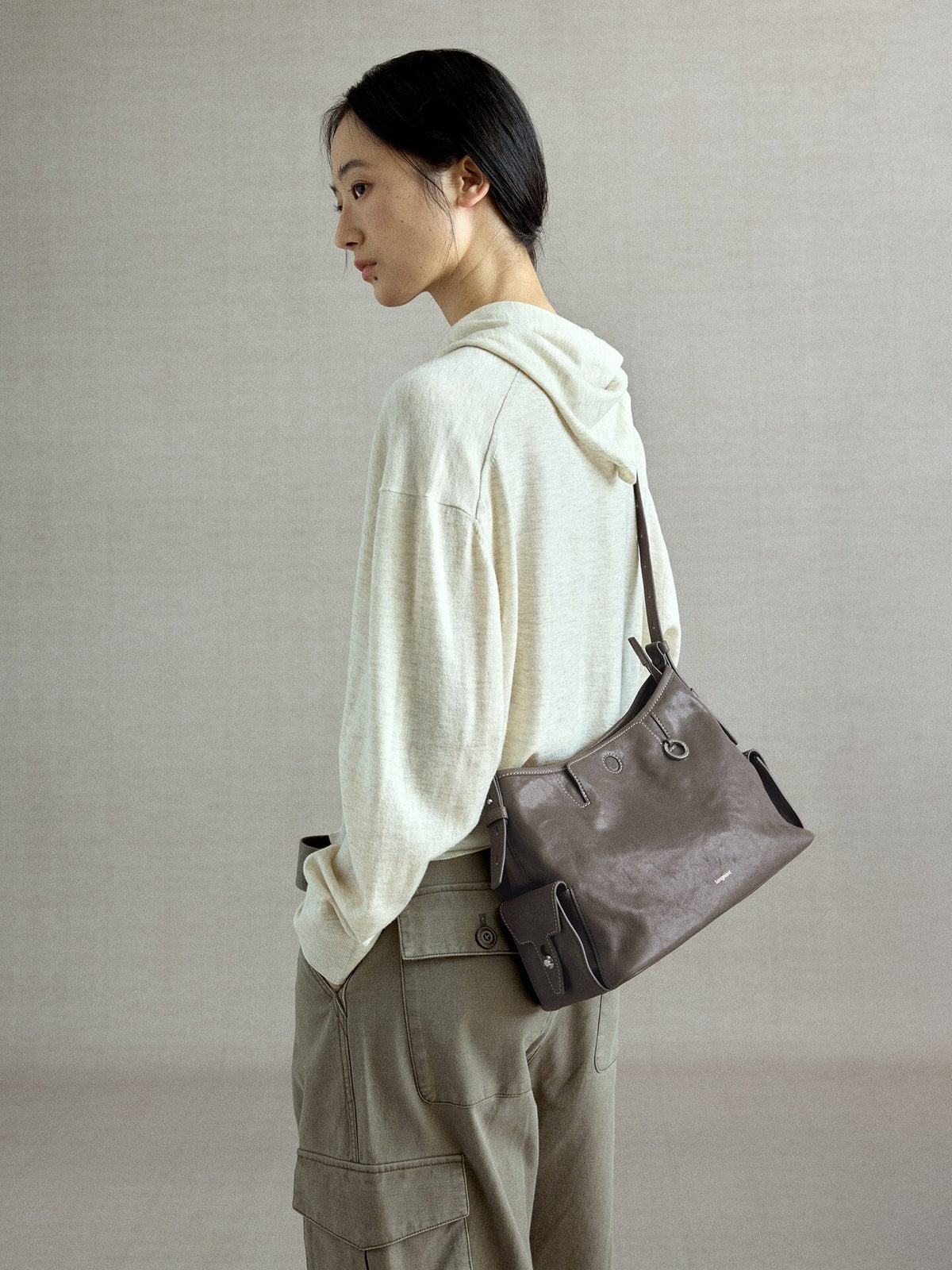 Songmont Medium Yore Hobo Bag Ink Grey worn on the shoulder