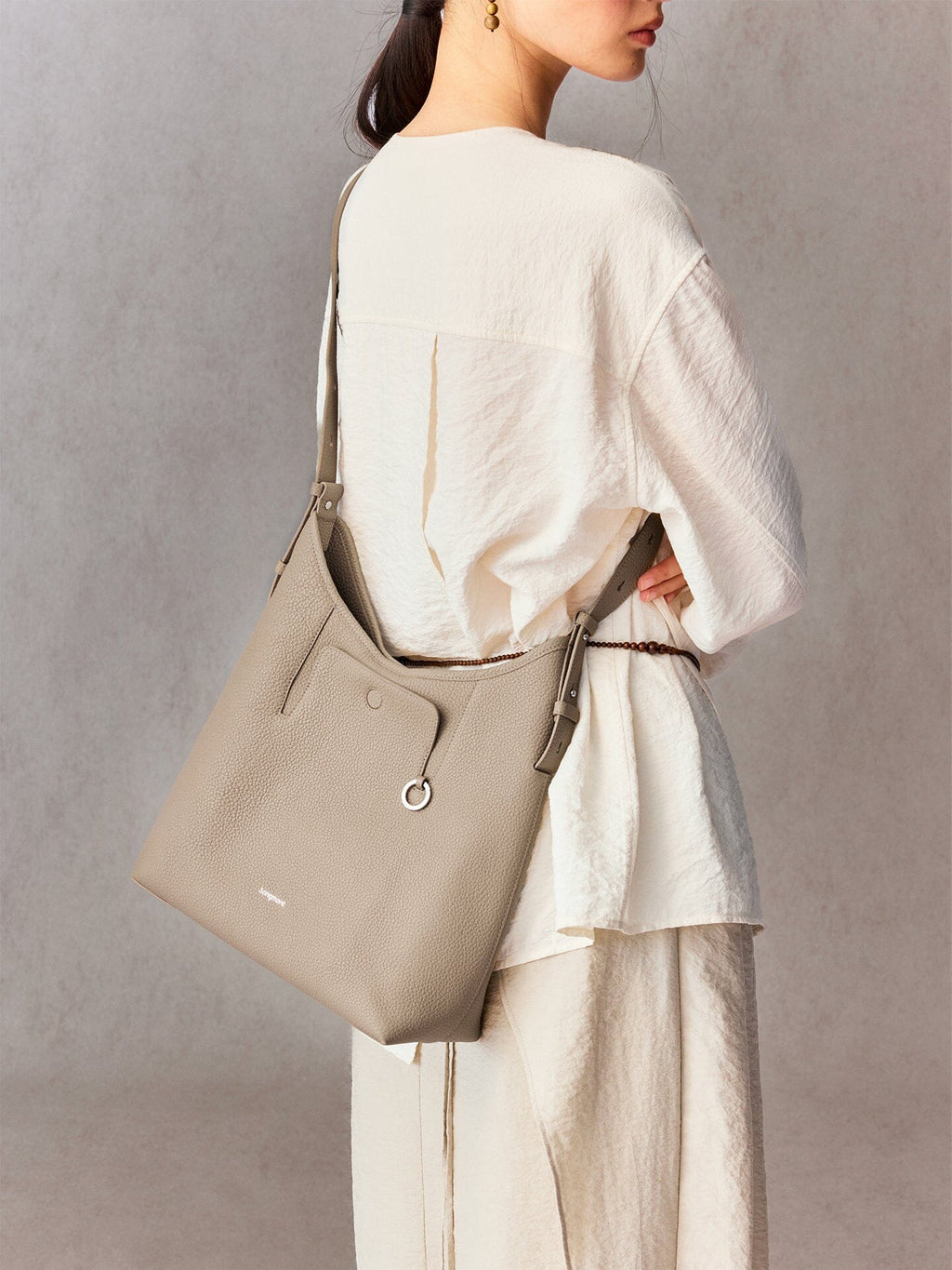 Songmont Medium Yore Shoulder Bag Smoke Grey - worn across the body, back view