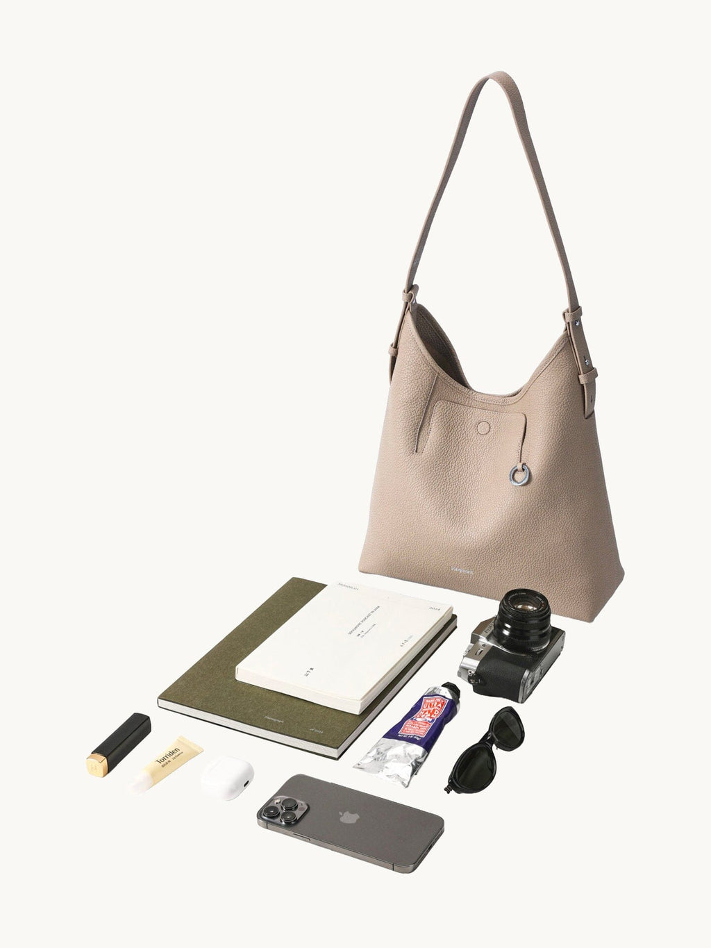 Songmont Medium Yore Shoulder Bag Smoke Grey - shown with everyday essentials laid out