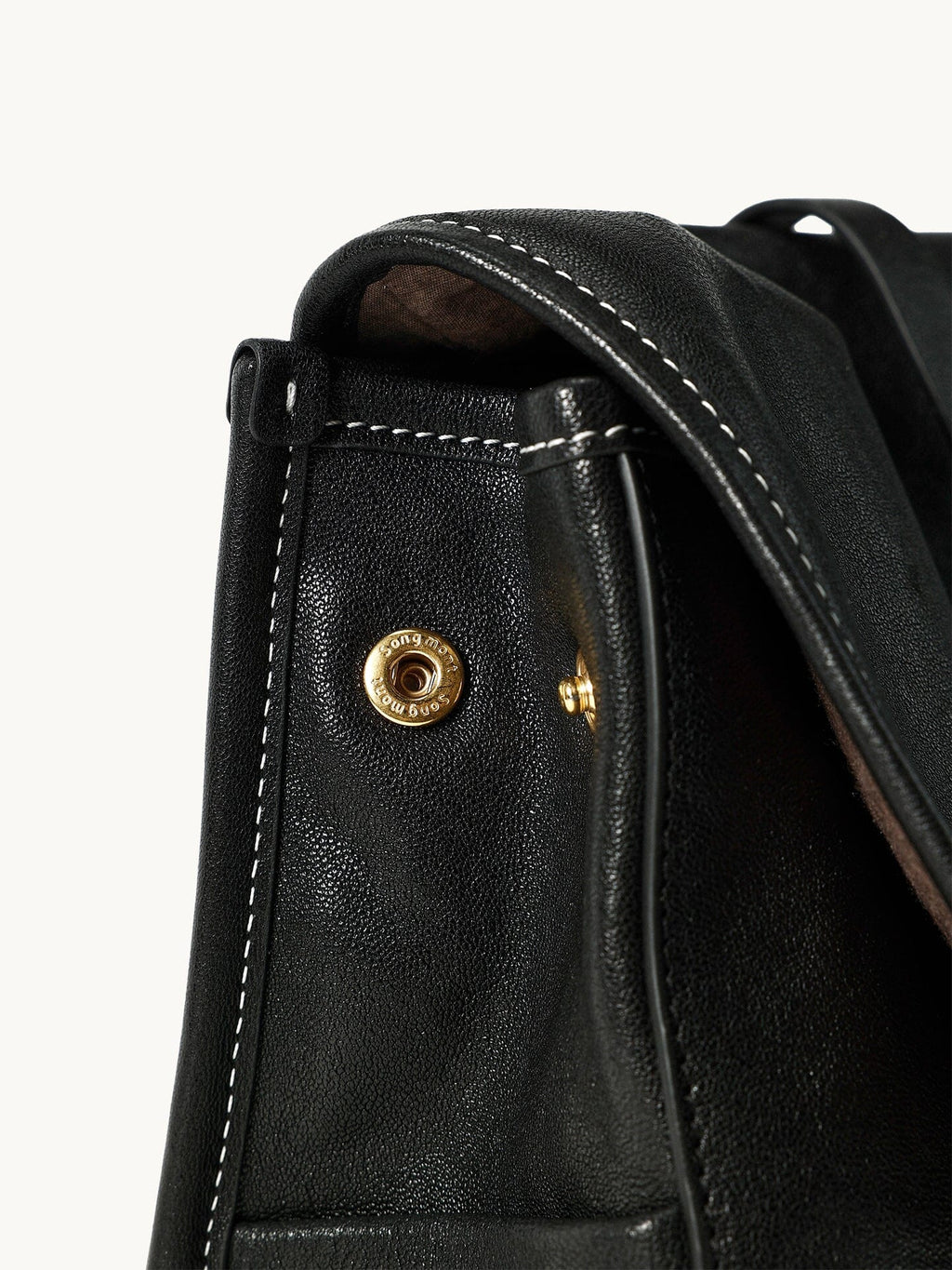 Songmont Mini Shan Backpack Onyx - side stud, top handle and flap edge