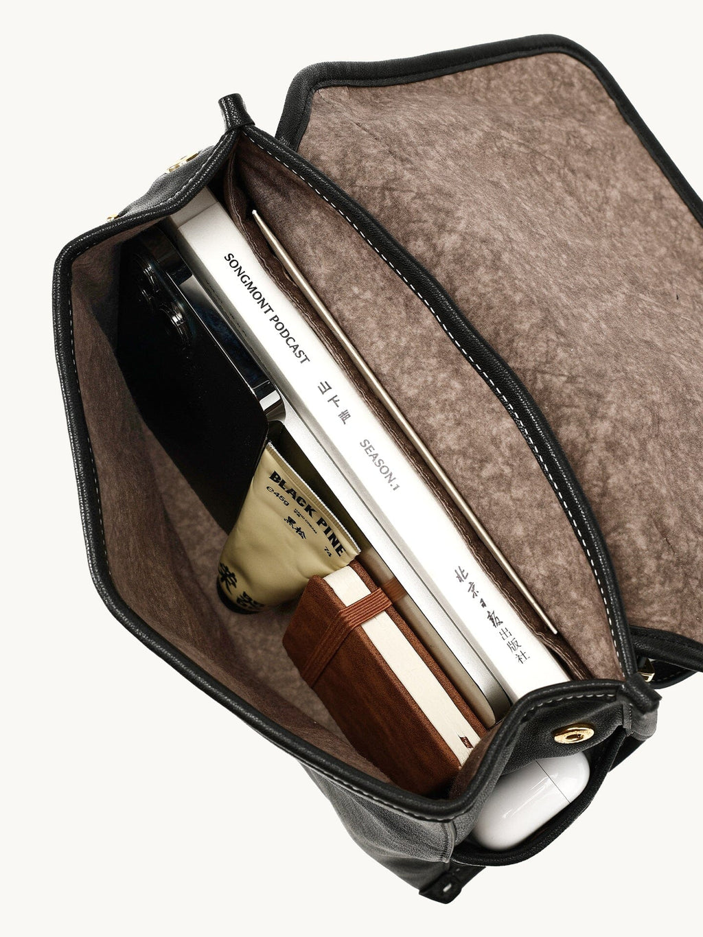 Songmont Mini Shan Backpack Onyx - open interior with fabric lining and books