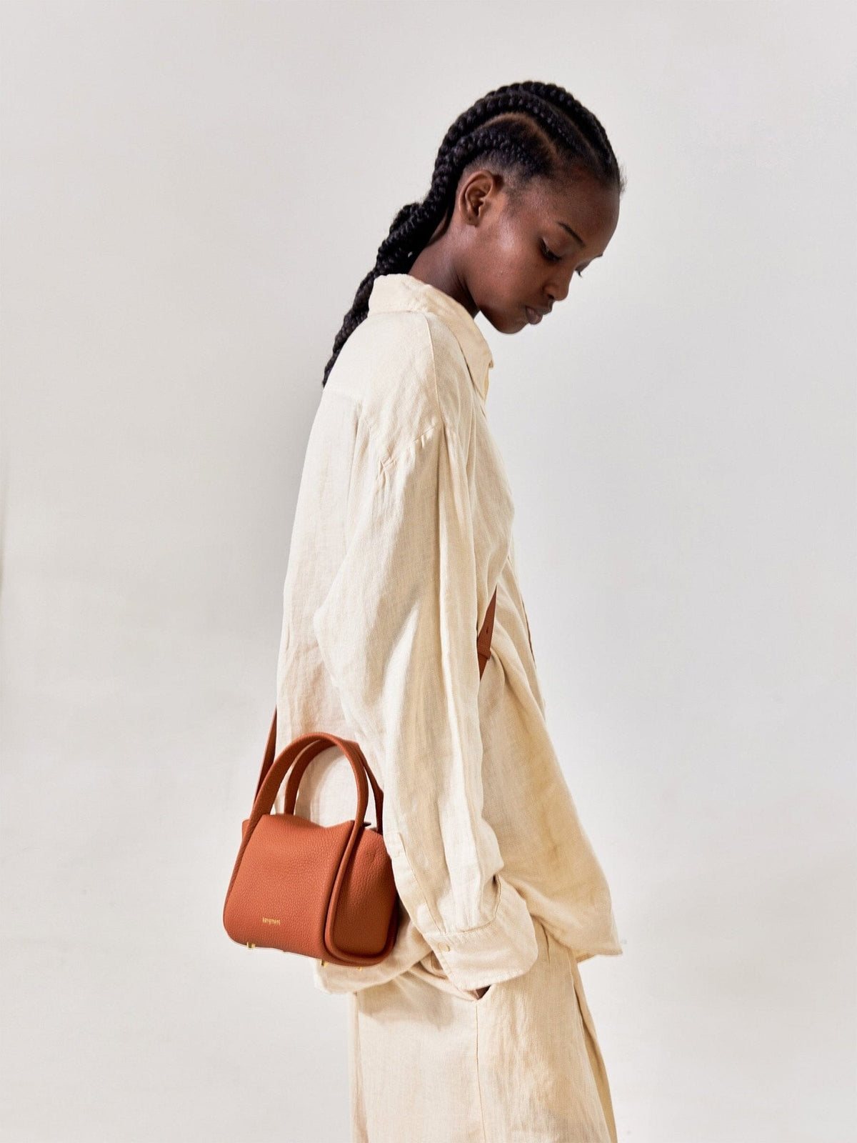 Songmont Mini Song Bag Brandy - worn cross-body, side view
