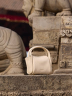 Songmont Mini Song Bag Ivory - styled on carved stone