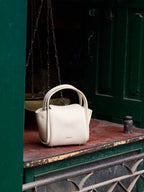 Songmont Mini Song Bag Ivory - styled against green doors
