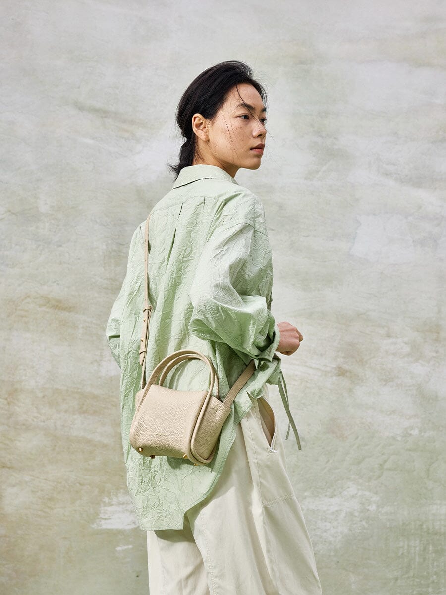 Songmont Mini Song Bag Ivory - carried by hand, full length