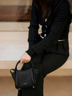 Songmont Mini Song Bag Onyx - carried by hand, seated