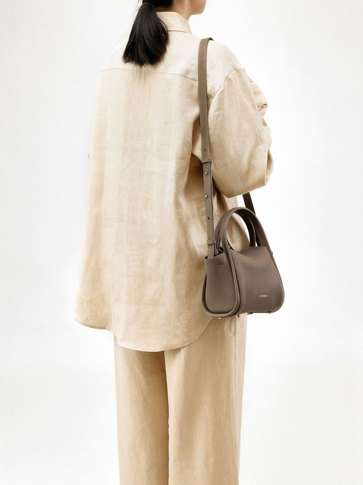 Songmont Mini Song Bag Taupe - worn cross-body, back view