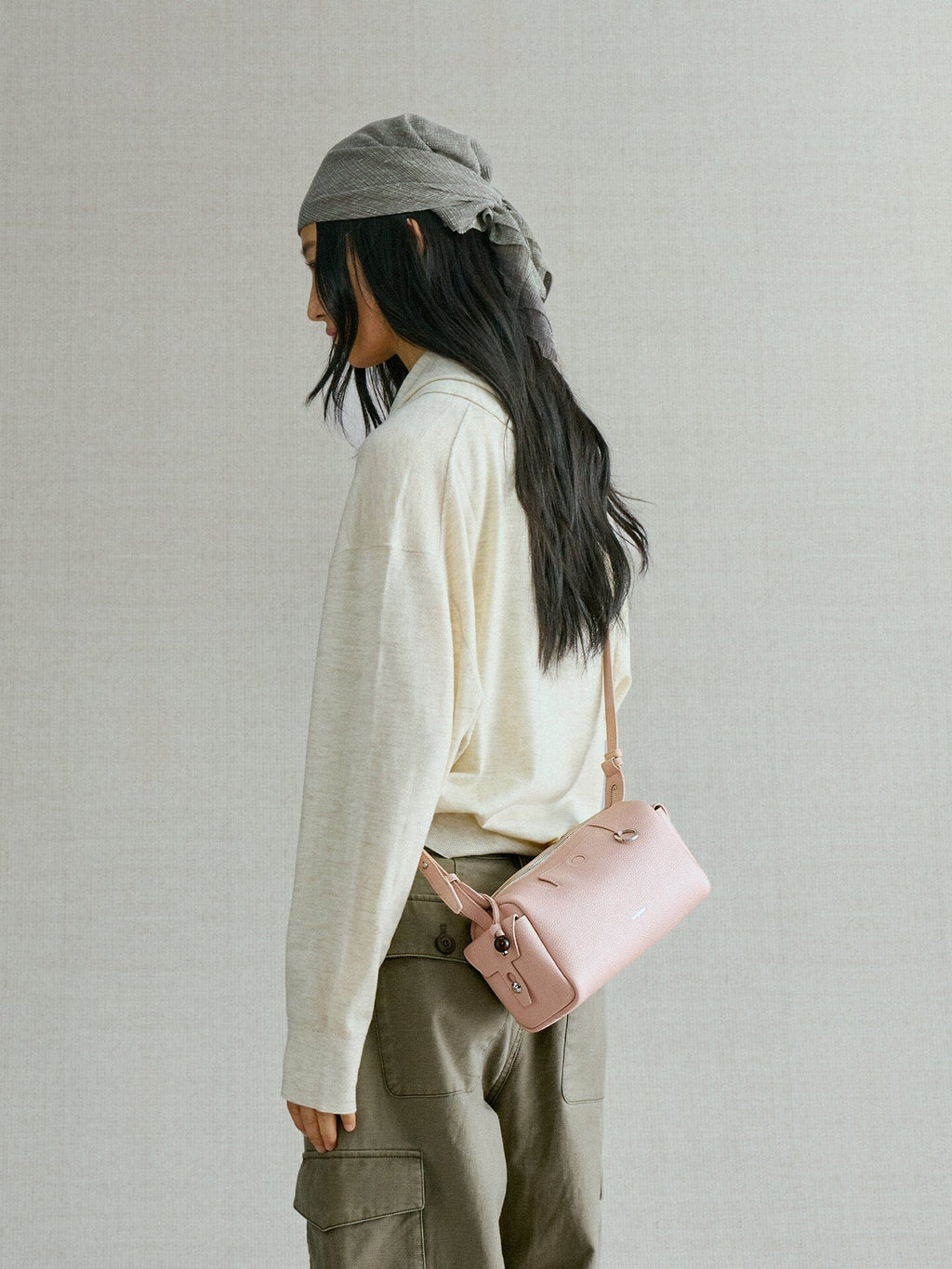 Songmont Mini Yore Camera Bag Peach - side view worn cross-body at the hip