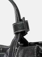 Songmont Mini Yore Duffle Bag Onyx - close-up of handle tab and contrast stitching