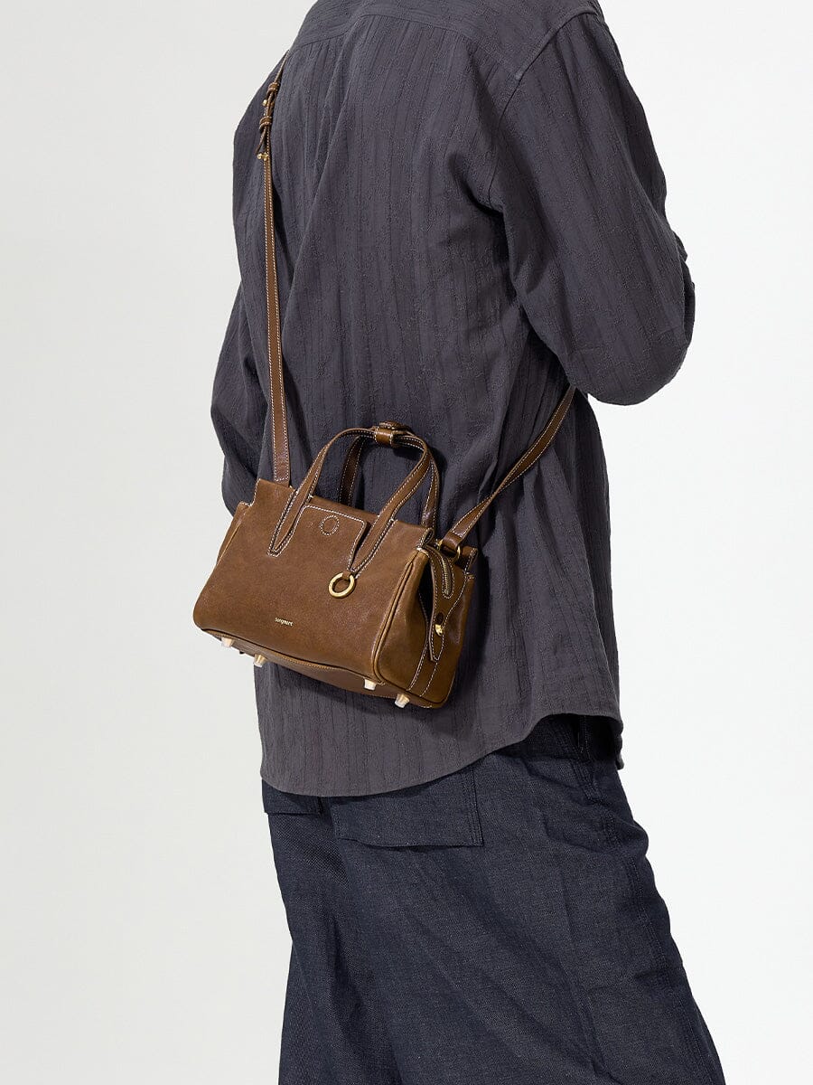 Songmont Mini Yore Duffle Bag Sandal - cross-body strap worn over a grey shirt