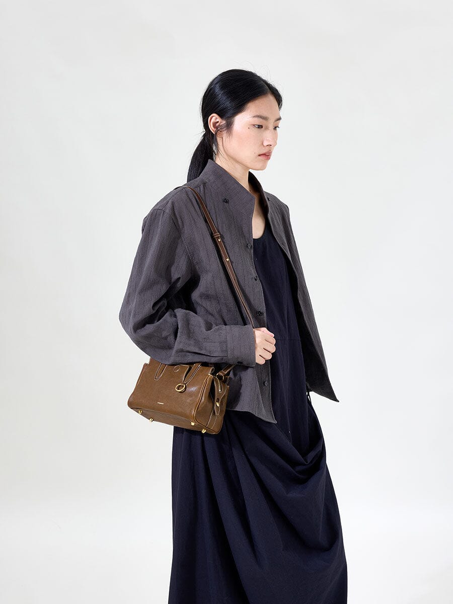 Songmont Mini Yore Duffle Bag Sandal - worn cross-body over a grey jacket