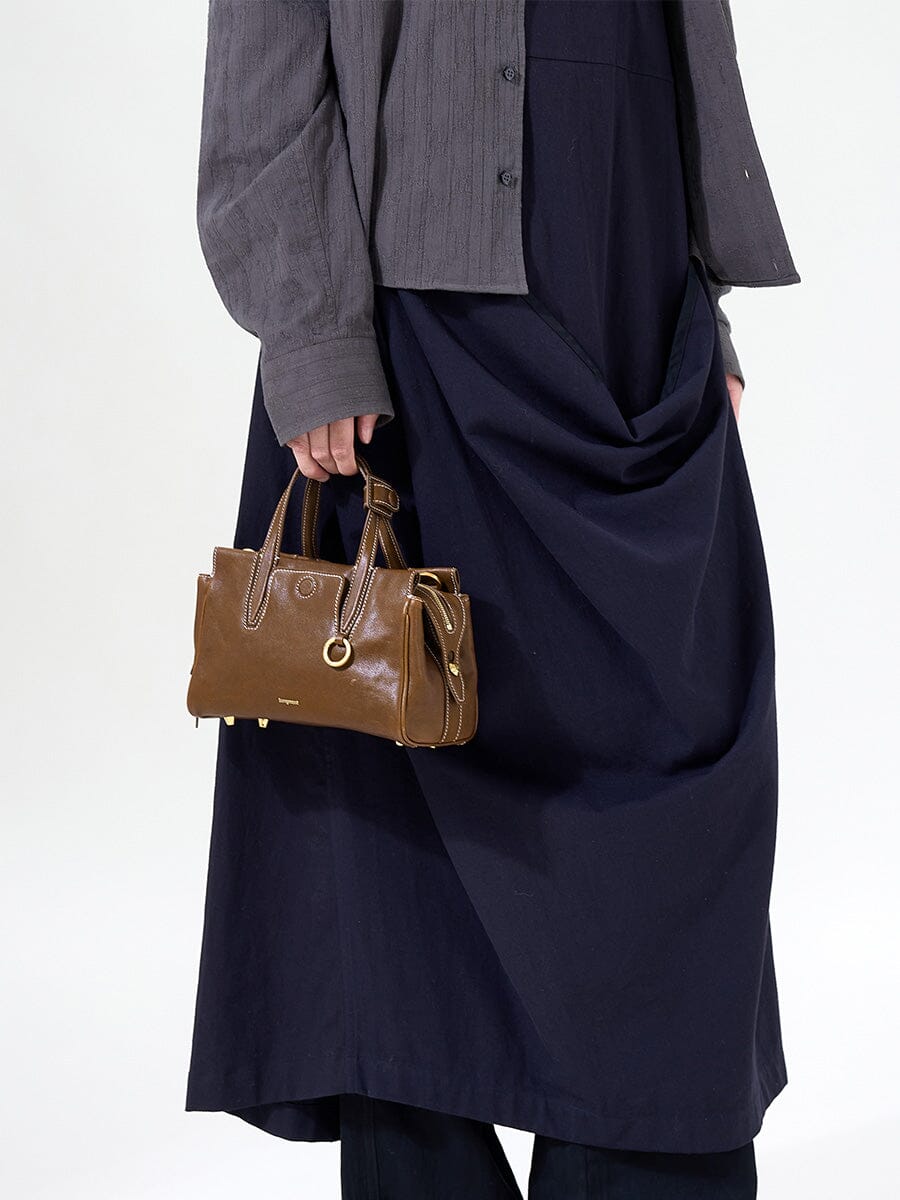 Songmont Mini Yore Duffle Bag Sandal - hand-carried with a navy dress