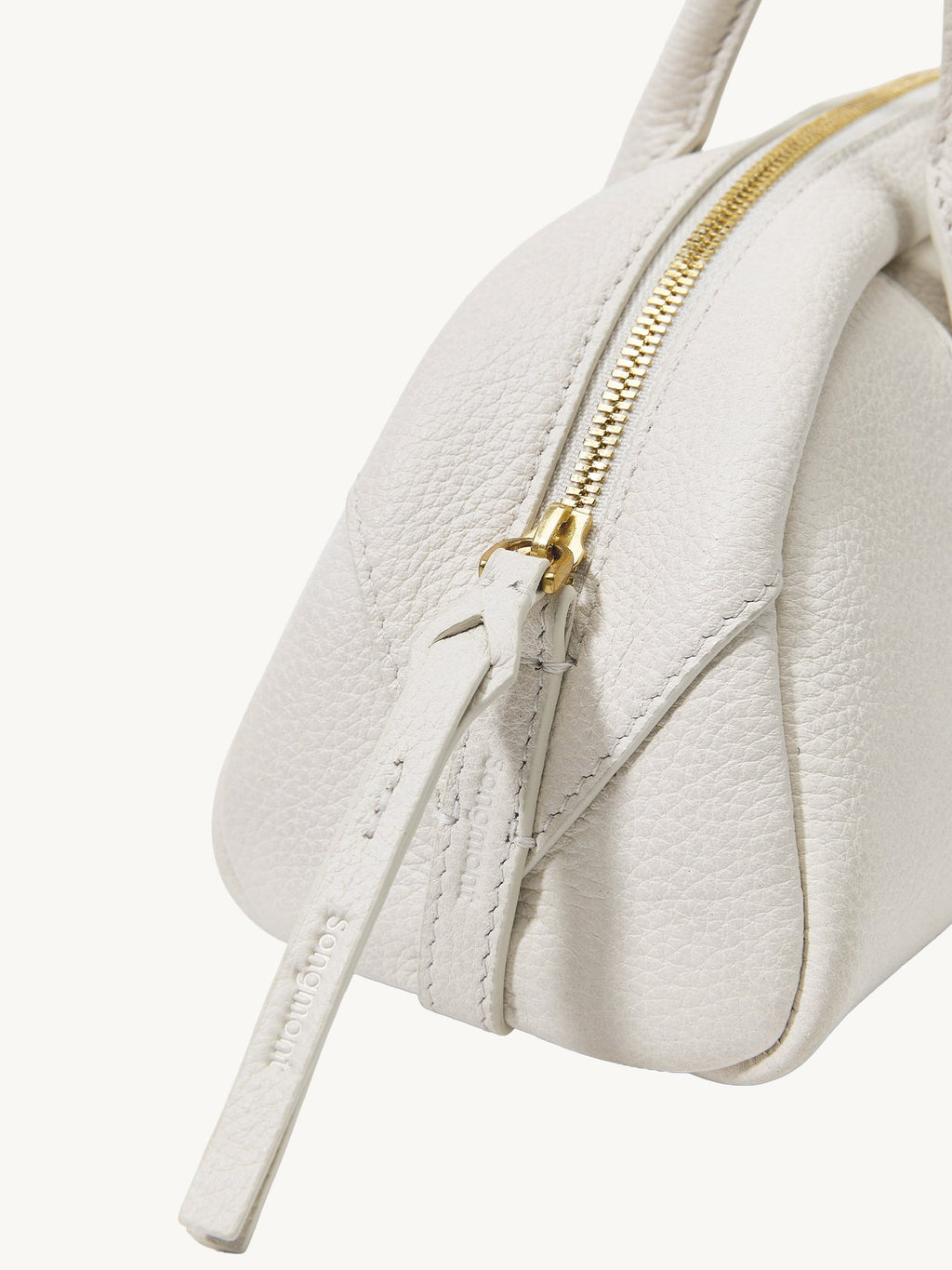 Songmont Mini Yore Toast Bag Cloud - gold zip end and leather grain close-up