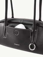 Songmont Mini Yore Toast Bag Ebony - front panel with AirPods in the slip pocket