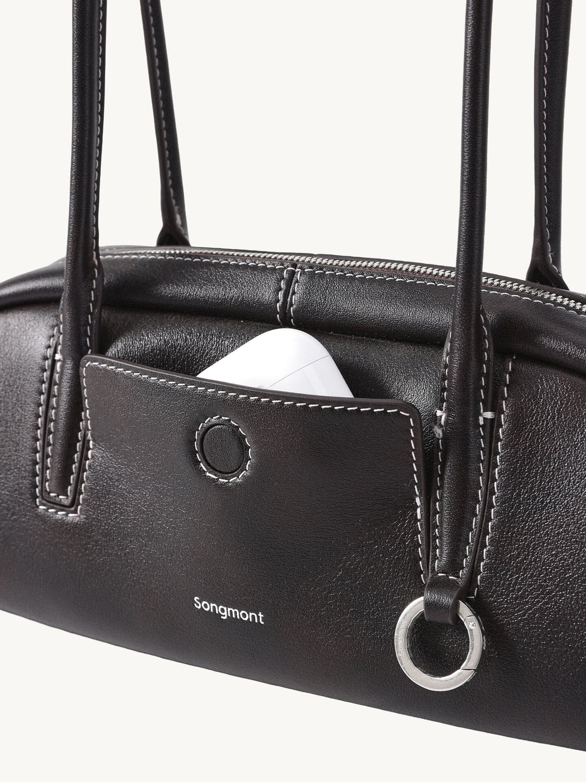 Songmont Mini Yore Toast Bag Ebony - front panel with AirPods in the slip pocket