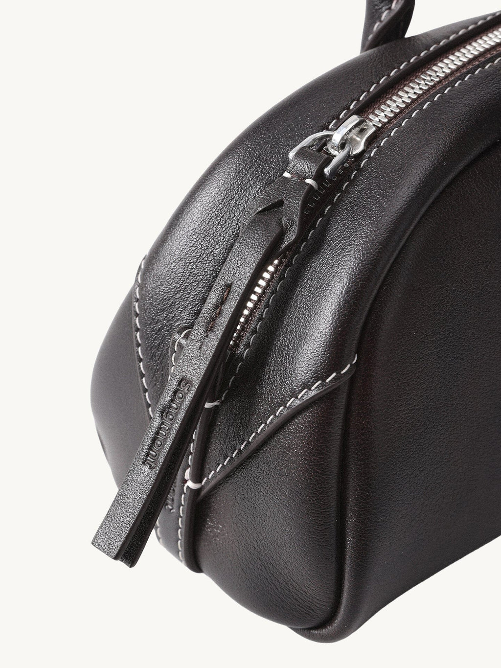 Songmont Mini Yore Toast Bag Ebony - zip end and leather close-up