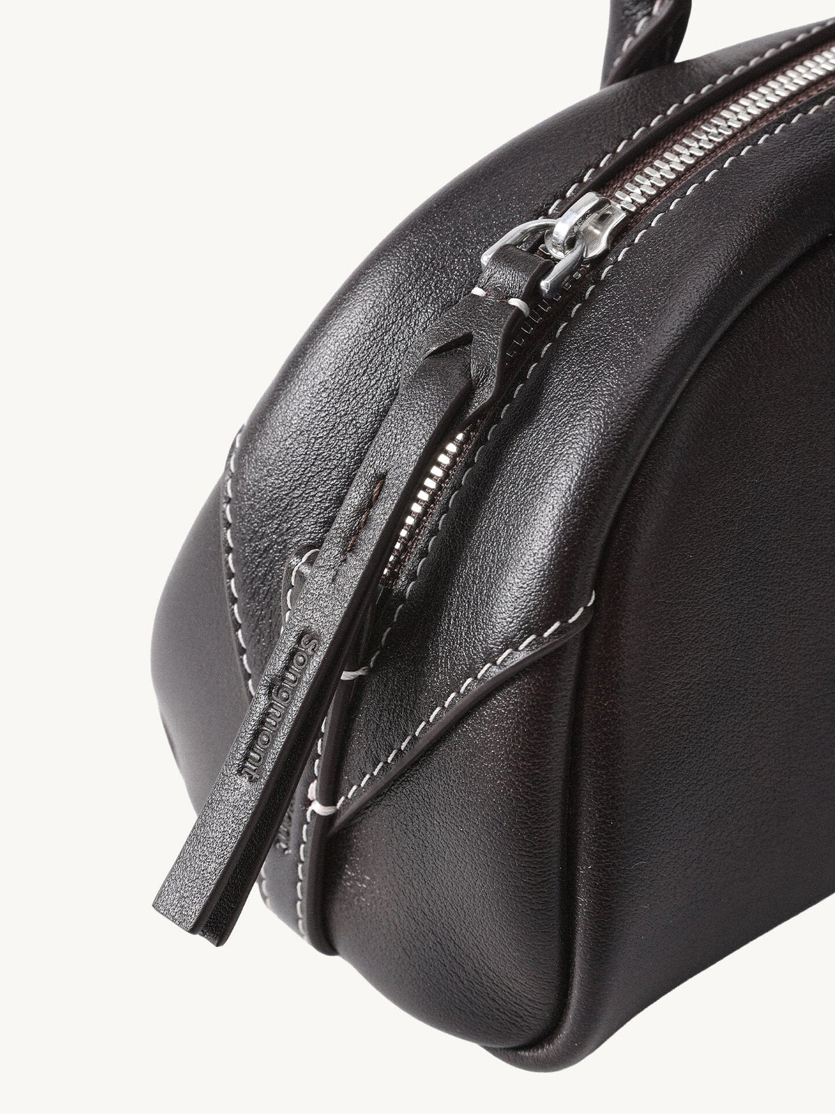 Songmont Mini Yore Toast Bag Ebony - zip end and leather close-up