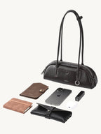 Songmont Mini Yore Toast Bag Ebony - flat lay with phone, wallet and everyday items