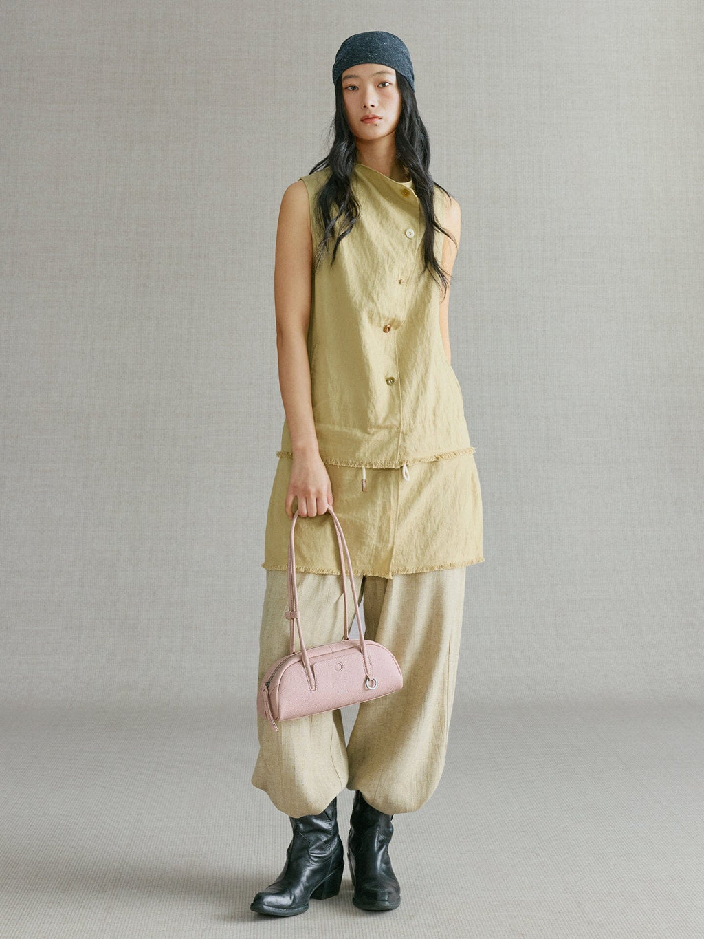 Songmont Mini Yore Toast Bag Peach - worn by model, carried by the top straps