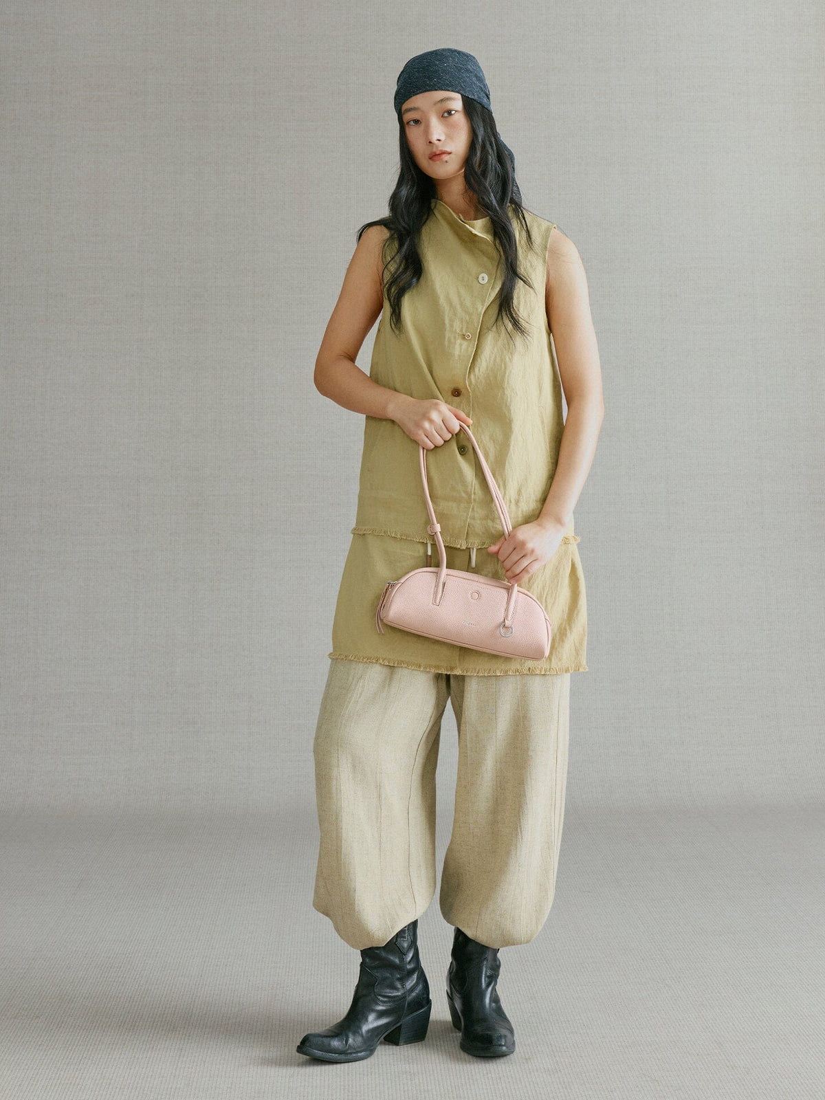 Songmont Mini Yore Toast Bag Peach - carried in hand by the straps