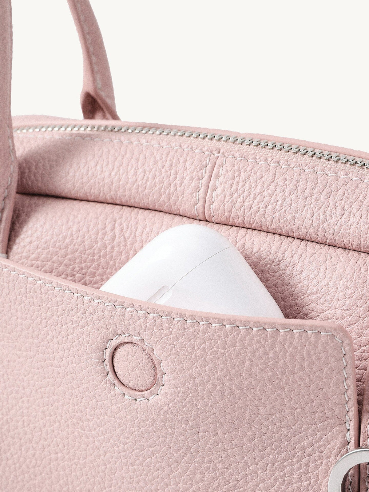 Songmont Mini Yore Toast Bag Peach - front panel with AirPods in the slip pocket