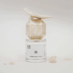 TO SUMMER Pomelo Eau de Parfum bottle with pomelo pulp on cap
