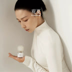 TO SUMMER Nude Eau de Parfum in hand, white turtleneck styling