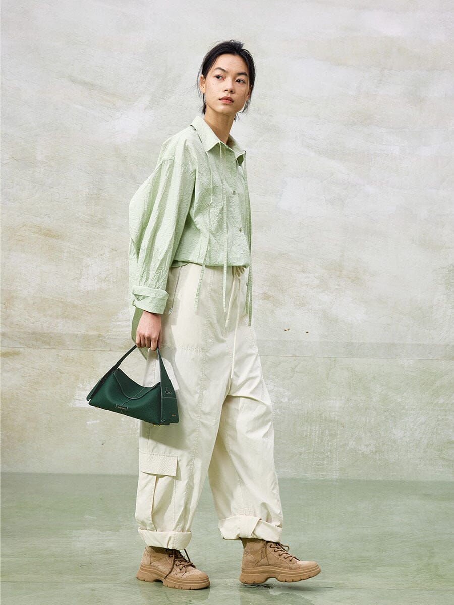 Songmont Small Drippy Roof Bag Emerald - carried by the handle, full-length look