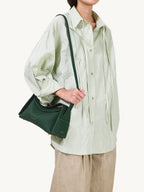Songmont Small Drippy Roof Bag Emerald - worn on the shoulder with the strap