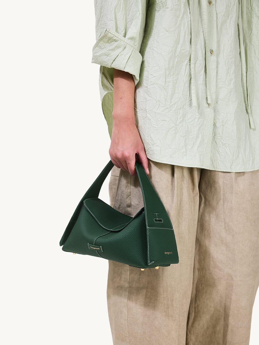 Songmont Small Drippy Roof Bag Emerald - carried by the handle at the hip