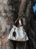 Songmont Small Gather Bag Cloud - hanging against a tree trunk