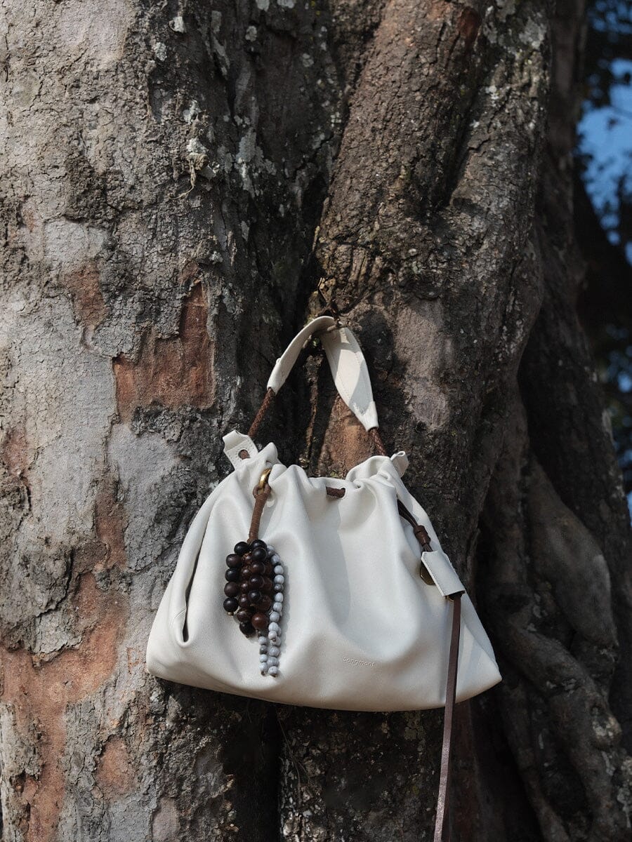 Songmont Small Gather Bag Cloud - hanging against a tree trunk