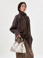 Songmont Small Gather Bag Cloud - carried by the top handle