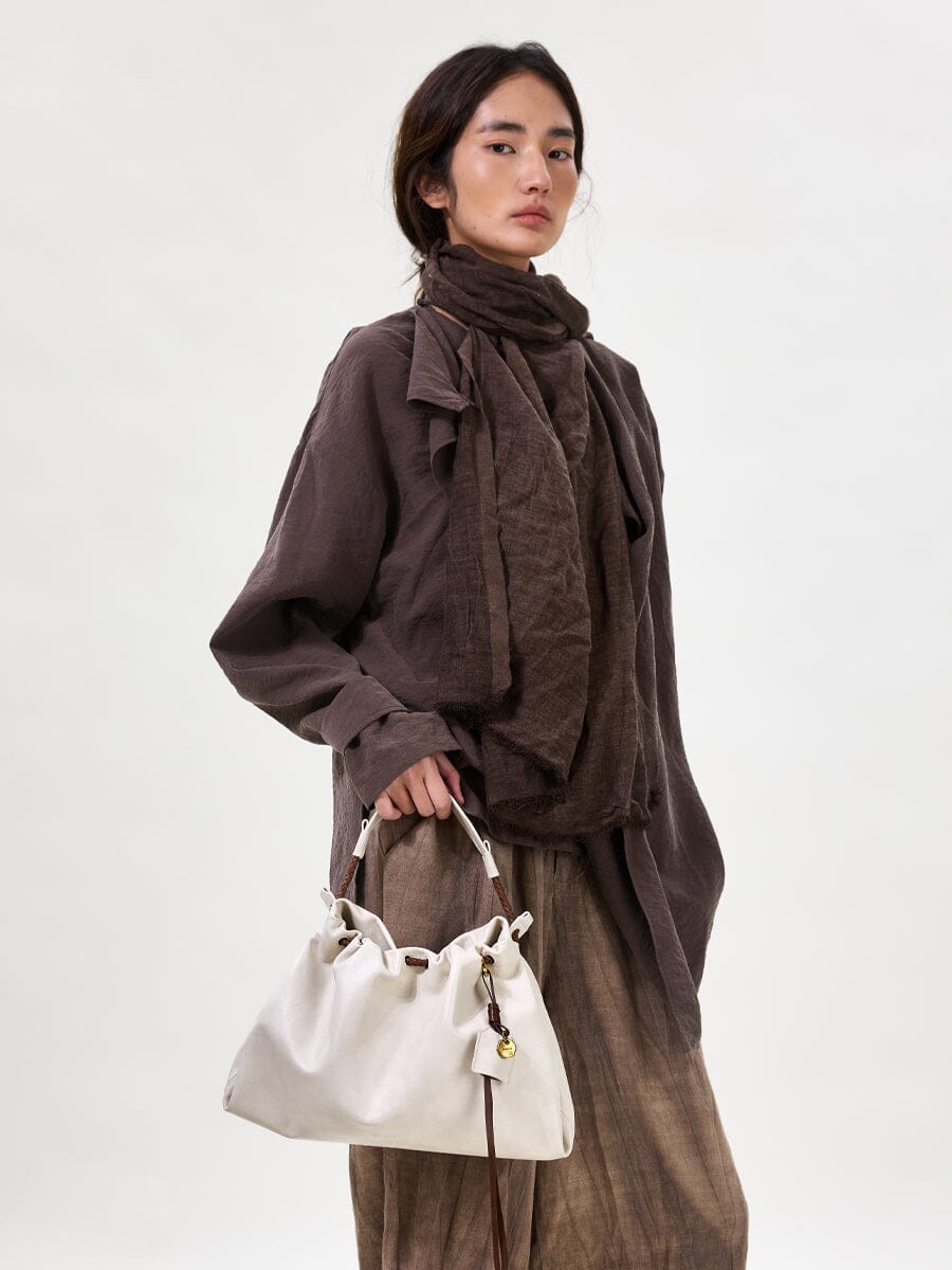 Songmont Small Gather Bag Cloud - carried by the top handle