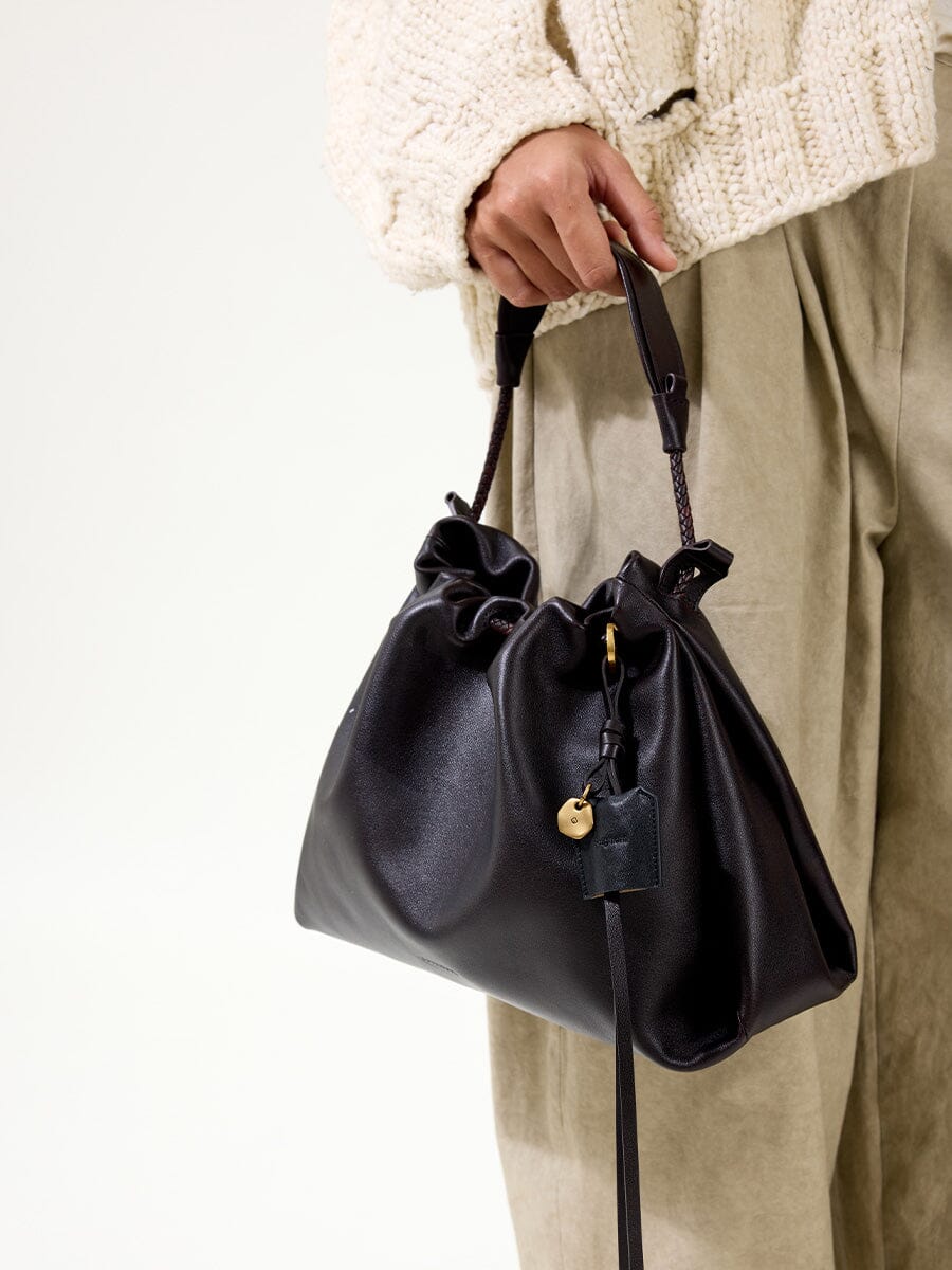 Songmont Small Gather Bag Ebony - carried by the top handle