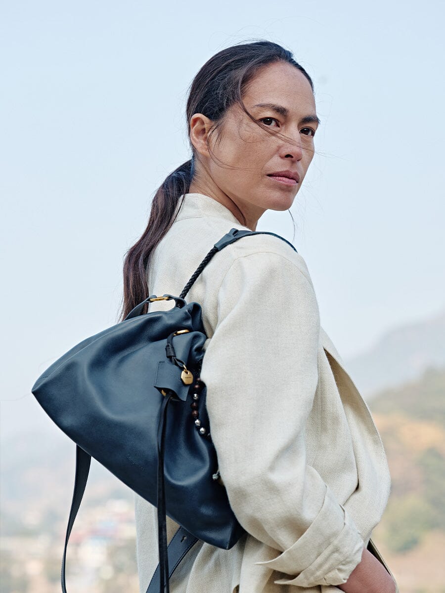 Songmont Small Gather Bag Navy - worn on the shoulder, side view