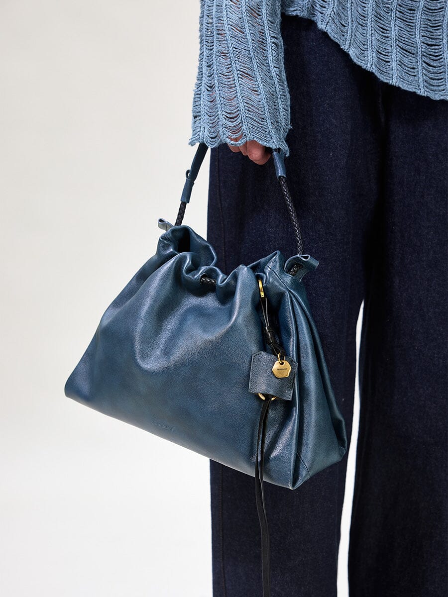 Songmont Small Gather Bag Navy - carried by the top handle