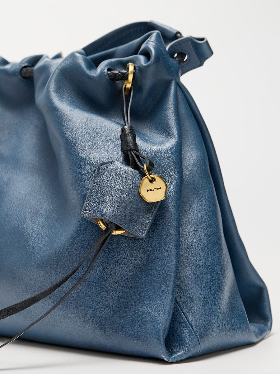 Songmont Small Gather Bag Navy - close-up of the drawstring and charm