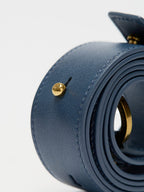 Songmont Small Gather Bag Navy - close-up of the coiled strap and gold stud