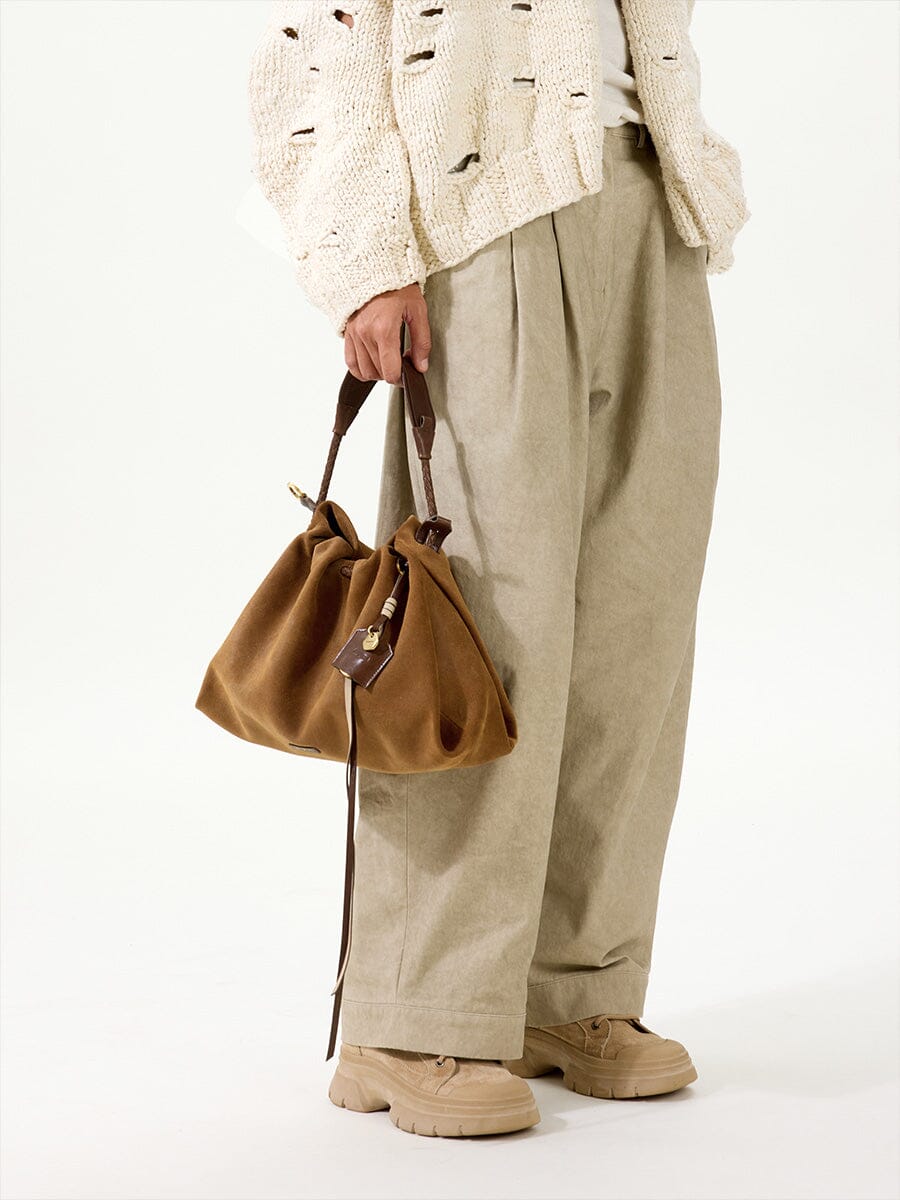 Songmont Small Gather Bag Ochre Suede - carried by the top handle