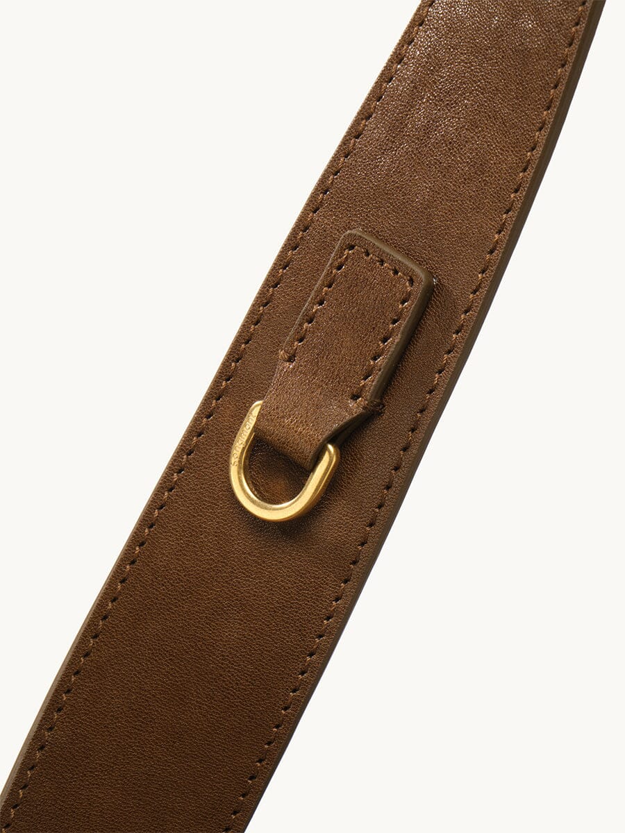 Songmont Small Gather Bag Ochre Suede - close-up of the strap and gold D-ring