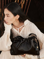 Songmont Small Gather Bag Onyx held in the lap