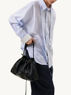 Songmont Small Gather Bag Onyx carried by the top handle