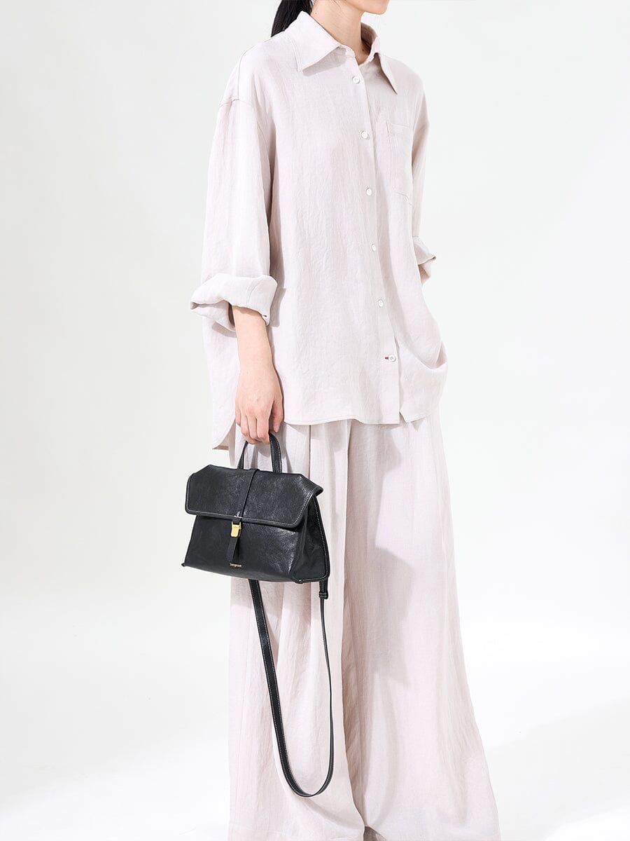 Songmont Small Shan Satchel Bag Onyx worn with linen outfit